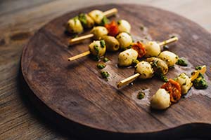 Menuserve Mediterranean Buffet Skewers from Central Foods close up on dark wood lscape medium